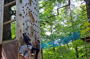Kinder beim Klettern an einer Kletterwand