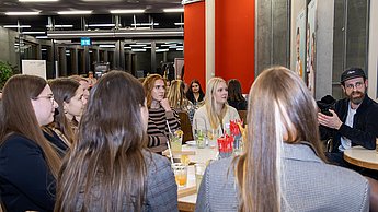 Studierendengruppe an Tisch sitzend