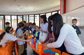 Kindergruppe schaut sich Lampenschirme aus dem 3D Druck an