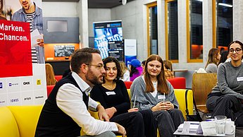 Ein Mann im Austausch mit Studierenden
