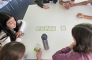 Kinder vergleichen unterschiedliche Tätigkeiten, die auf Karten gedruckt sind