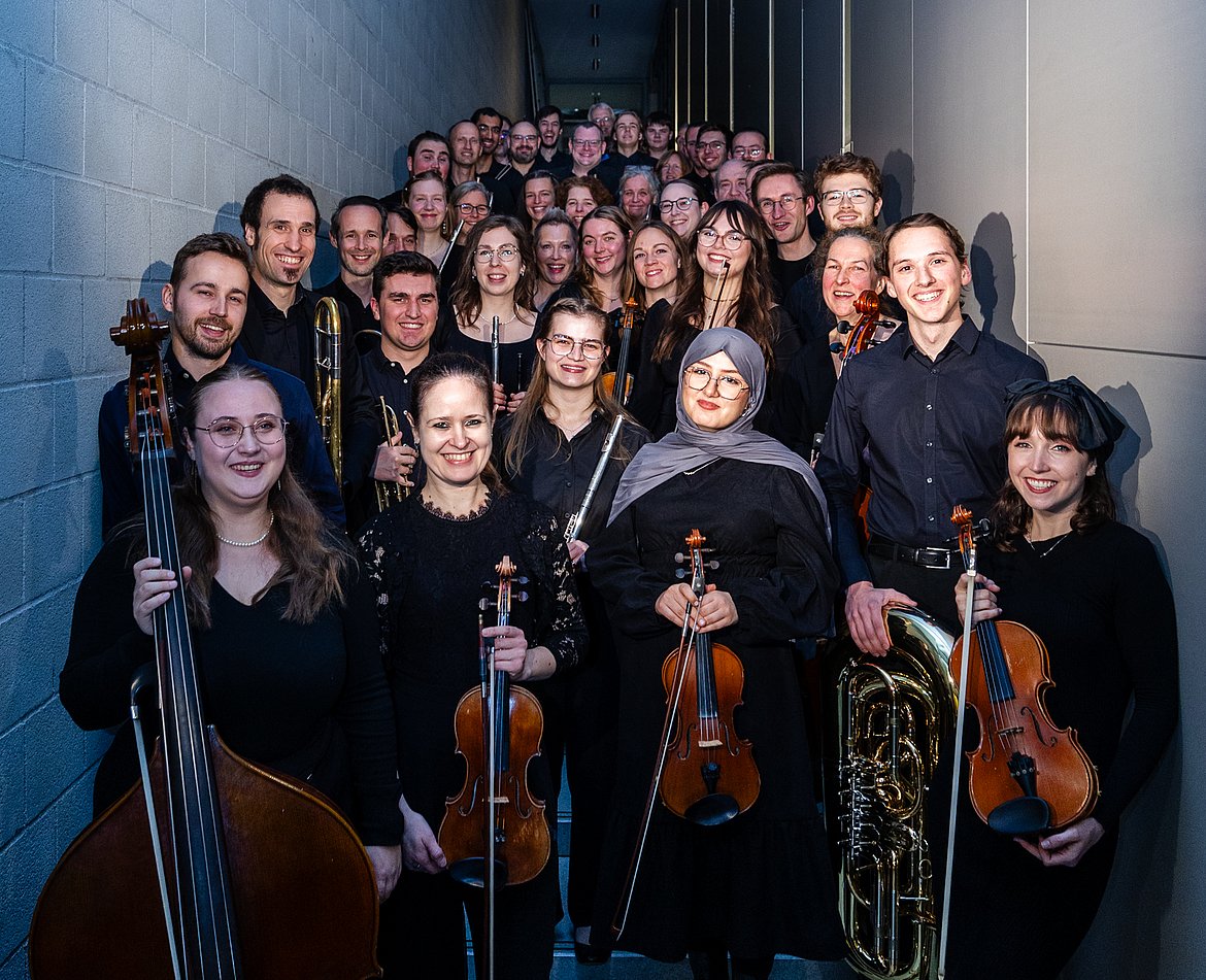 Das Orchester der Hochschule posiert mit ihren Instrumenten