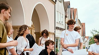 Personen stehen vor einem Gebäude