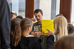 Wie entsteht eigentlich Bienenhonig? Hier zeigt Felix Bischoff den Kindern Gerätschaften dazu.